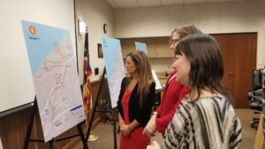 Community leaders review a Route 8 option on a large