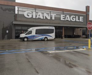 Small Dial a Ride bus in front of Giant Eagle store